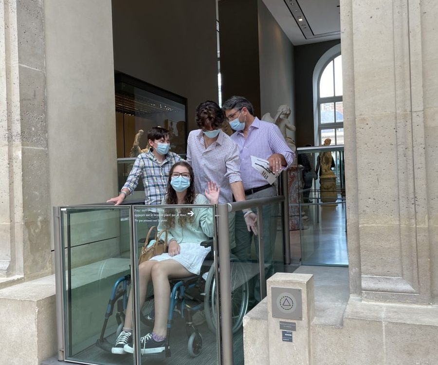 In a museum trying to maneuver a wheelchair elevator that did not work. Brian ended up carrying the wheelchair down a set of stairs while the boys held Rebecca. This happens all the time….