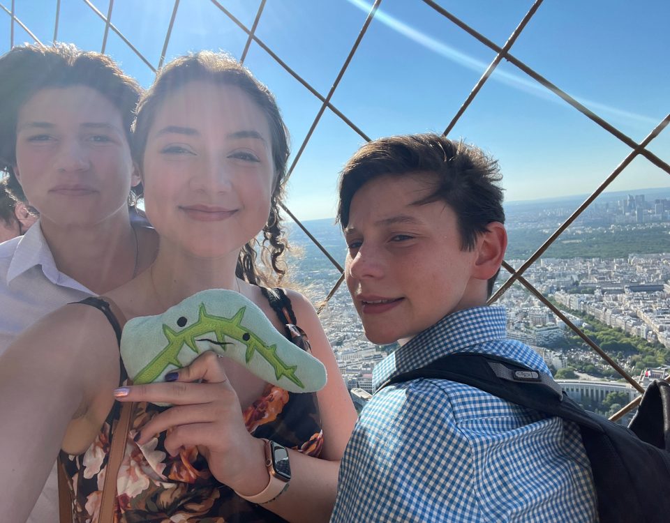 Pierre the Pancreas with Rebecca Taylor and her brothers atop the Eiffel Tower in Paris, France.